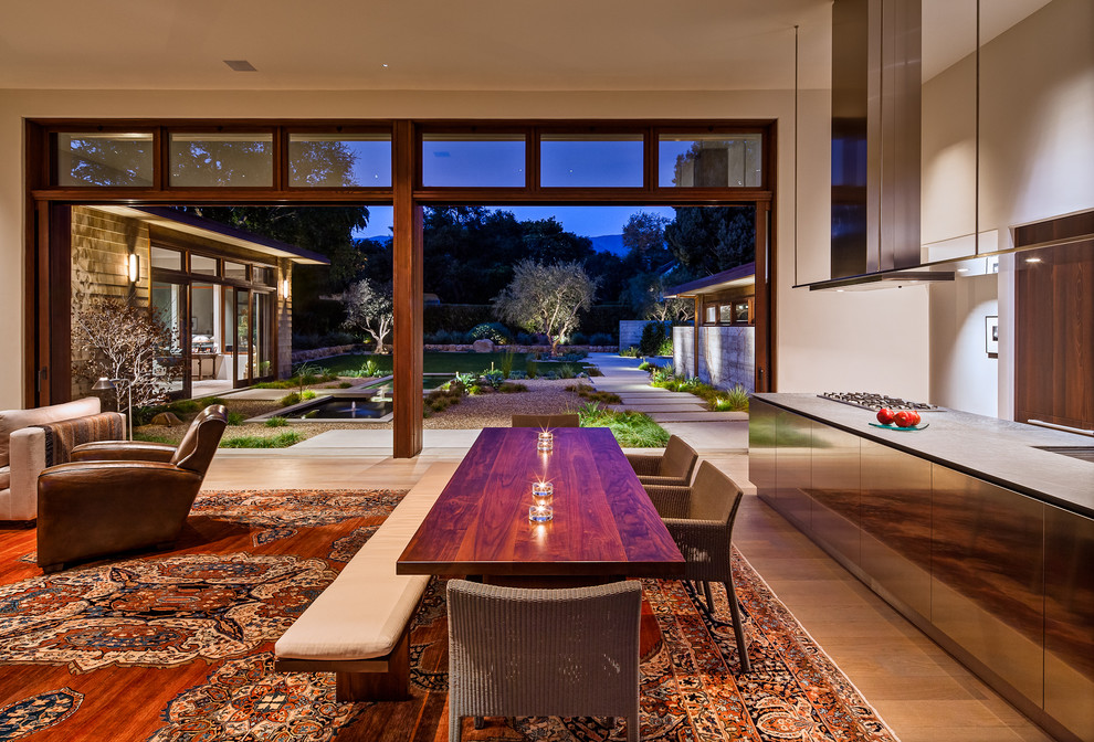 Contemporary open plan dining room in Santa Barbara with white walls and medium hardwood flooring.