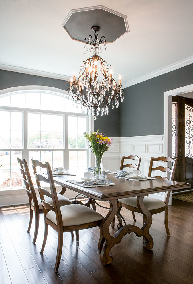 Enclosed dining room - traditional dark wood floor enclosed dining room idea in Raleigh with black walls