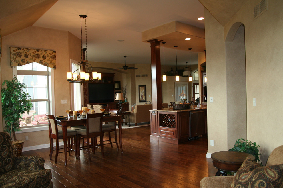 Large elegant dark wood floor great room photo in Milwaukee with beige walls, a standard fireplace and a stone fireplace