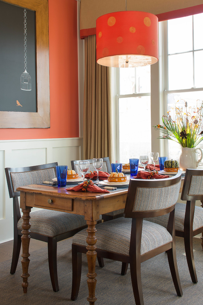 Dining room - mid-sized transitional dining room idea in New York with orange walls