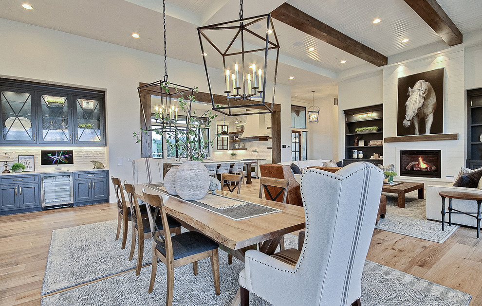 Expansive country open plan dining room in Portland with beige walls, light hardwood flooring, no fireplace and brown floors.