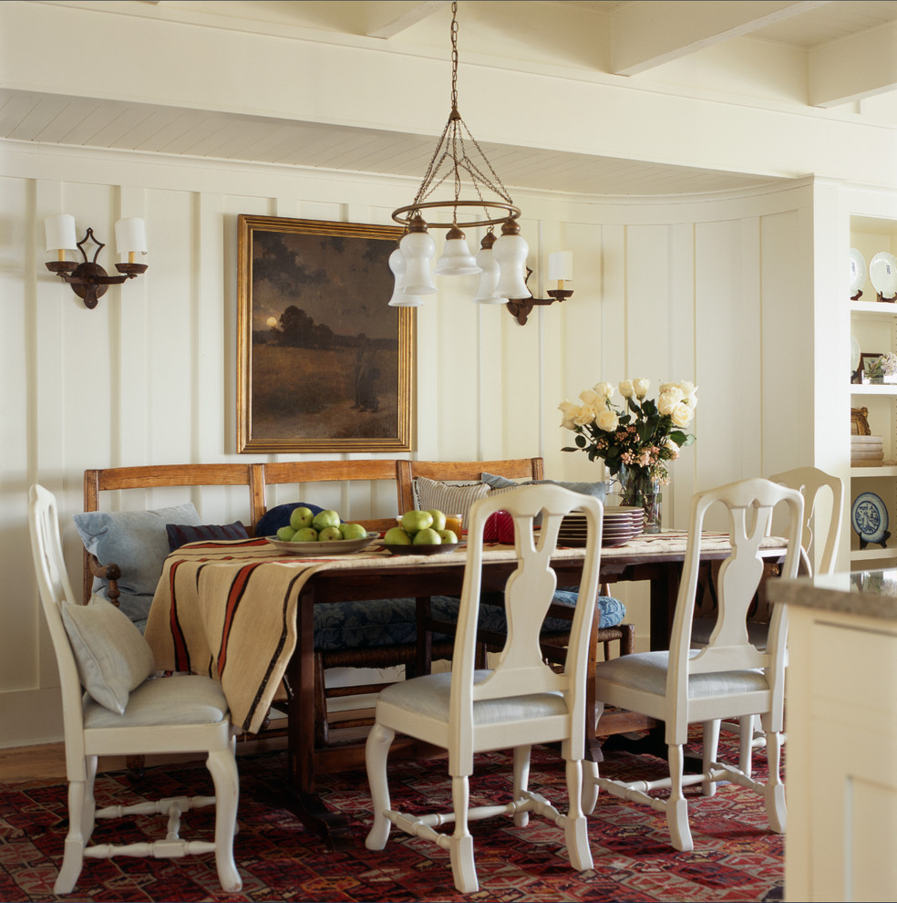 Photo of a beach style dining room in DC Metro with white walls and medium hardwood flooring.