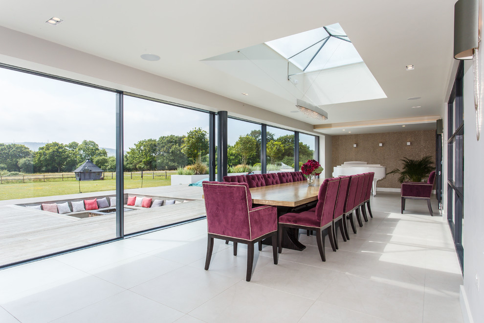 Contemporary enclosed dining room in Sussex with white walls and beige floors.