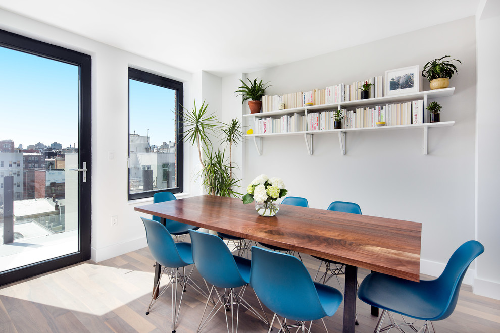 Enclosed dining room - mid-sized contemporary medium tone wood floor and beige floor enclosed dining room idea in New York with gray walls
