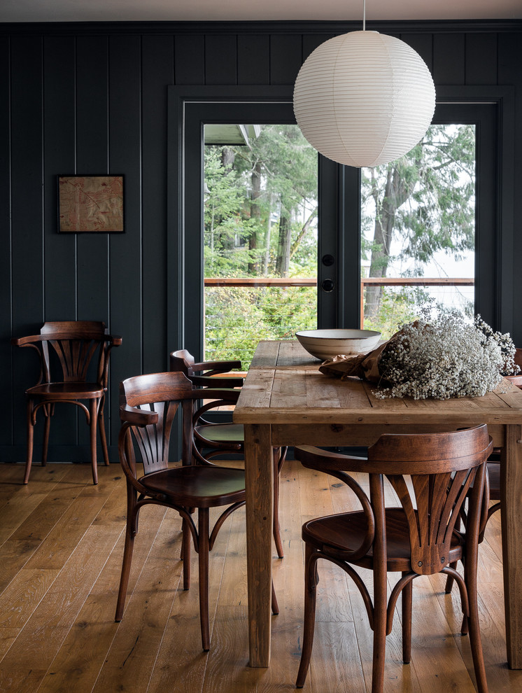 Photo of a rustic enclosed dining room in Seattle with green walls, medium hardwood flooring and brown floors.