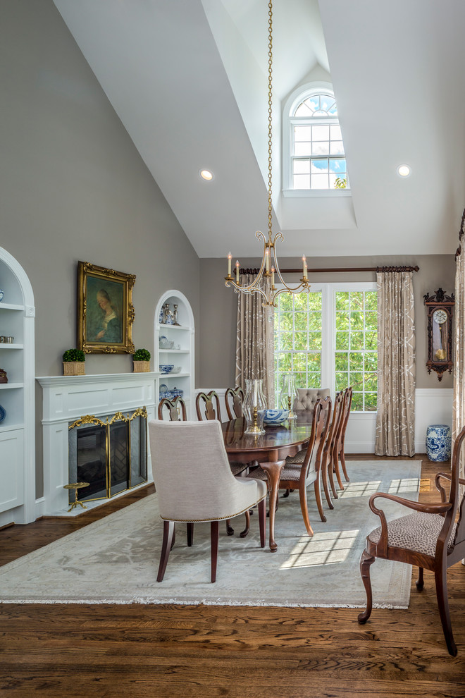 Traditional dining room in Baltimore with grey walls, a standard fireplace and dark hardwood flooring.