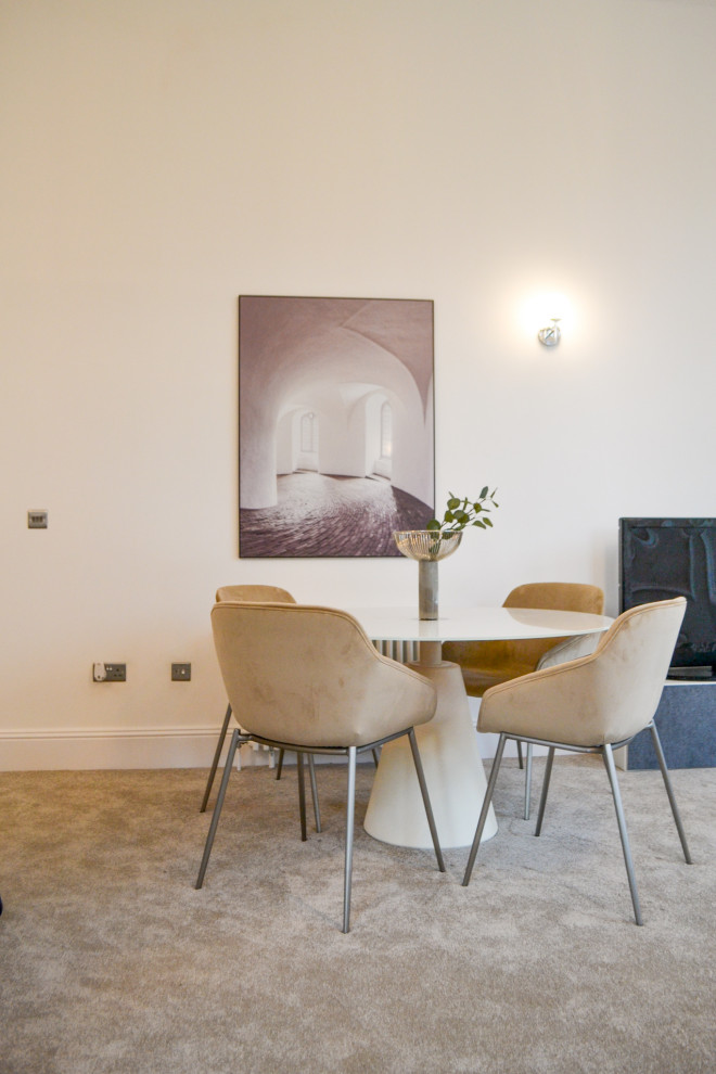 Inspiration for a small contemporary open plan dining room in Glasgow with white walls, carpet, a standard fireplace and grey floors.