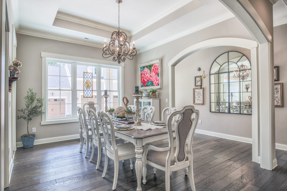 Inspiration for a large french country dark wood floor, brown floor and tray ceiling dining room remodel in Other with beige walls