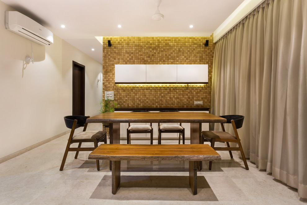 Example of a trendy dining room design in Mumbai