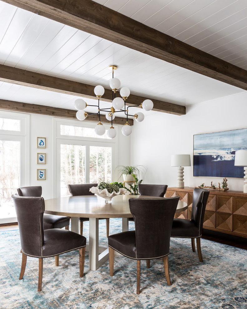 Example of a beach style dining room design in New York with white walls and no fireplace