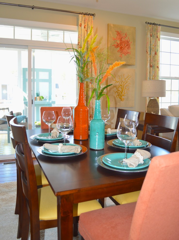 This is an example of a nautical dining room in DC Metro with yellow walls and medium hardwood flooring.