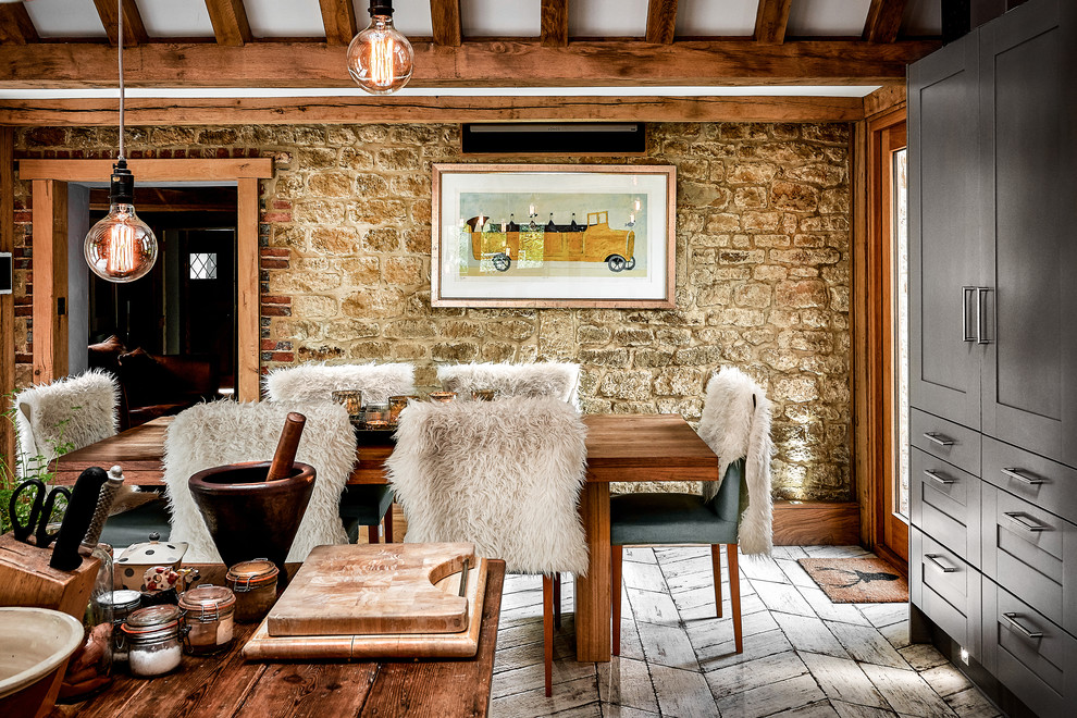 Photo of a country kitchen/dining room in Hampshire with white floors and brown walls.