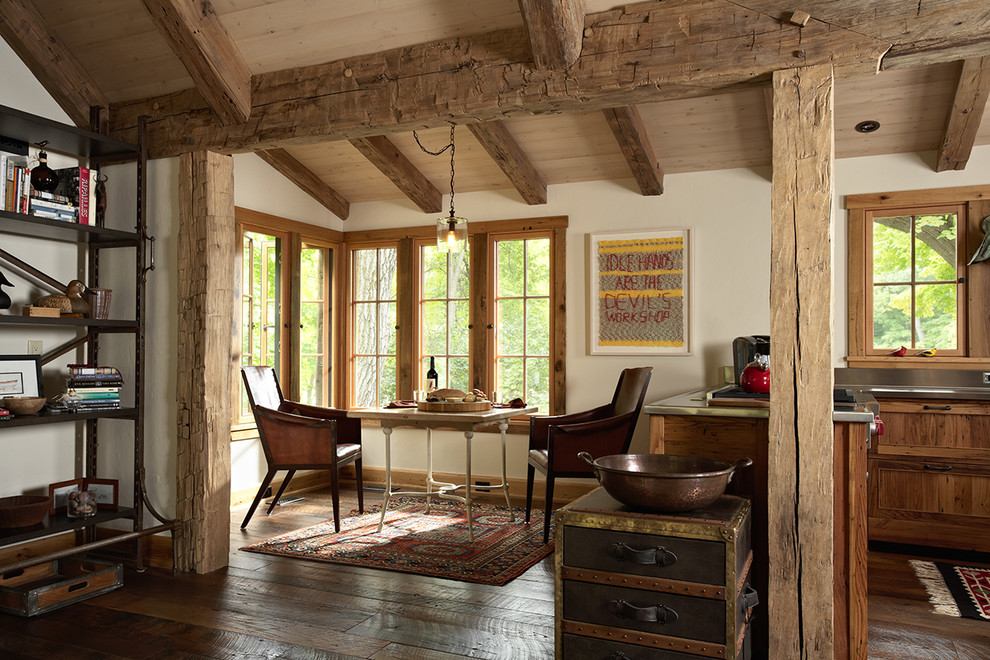 Example of a mountain style dark wood floor kitchen/dining room combo design in Minneapolis with white walls