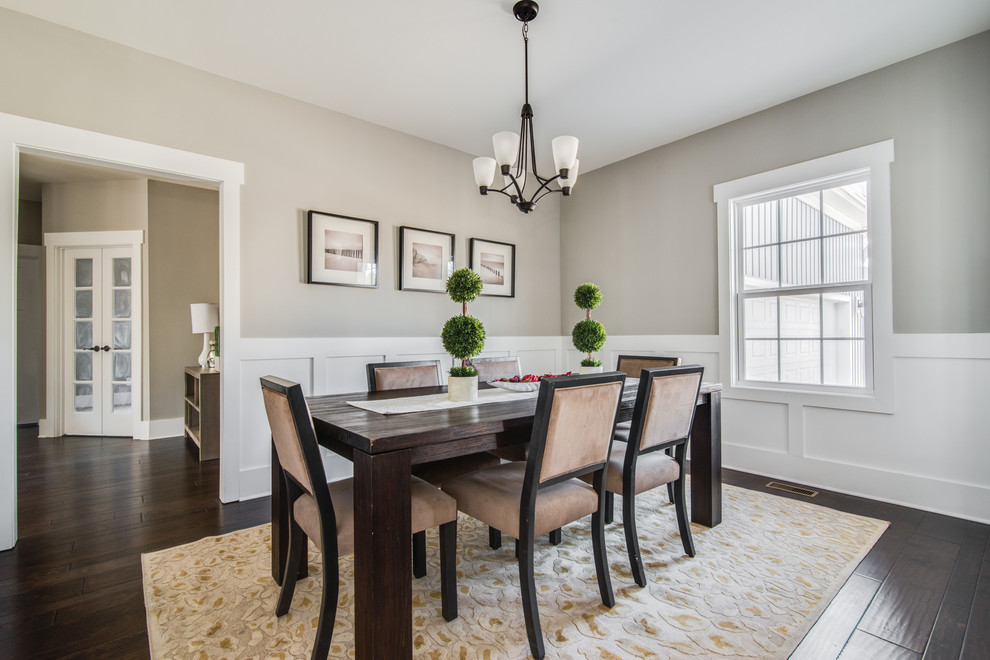 This is an example of a medium sized classic enclosed dining room in Charlotte with grey walls, dark hardwood flooring, no fireplace and brown floors.