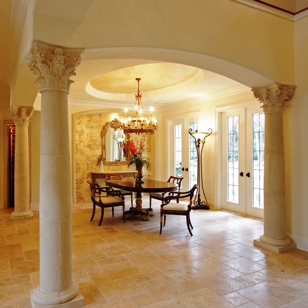 Inspiration for a small mediterranean travertine floor dining room remodel in Jacksonville with beige walls