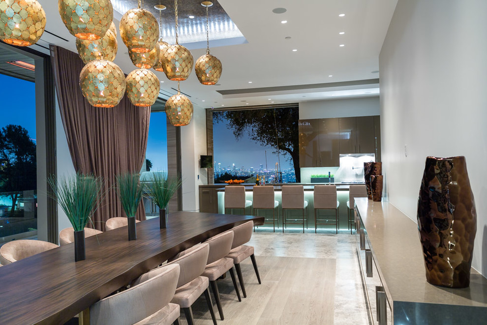 This is an example of a large contemporary open plan dining room in Los Angeles with grey walls.