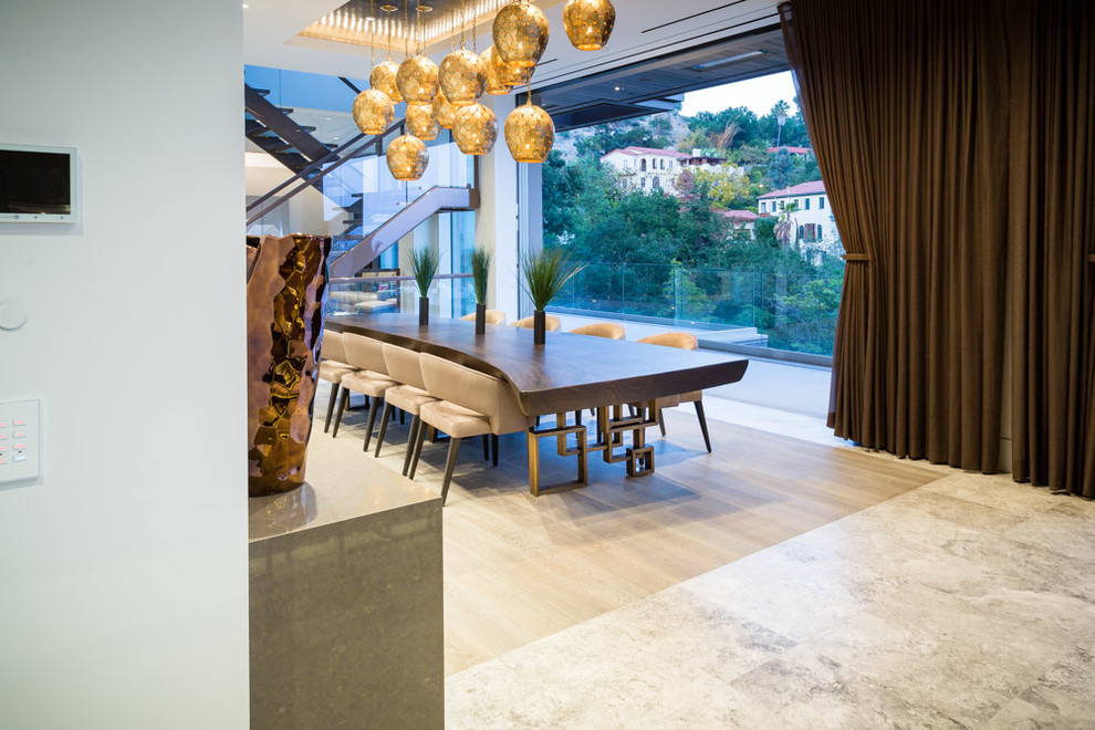 This is an example of an expansive contemporary open plan dining room in Los Angeles with grey walls.