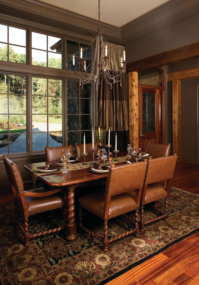 Aménagement d'une grande salle à manger ouverte sur le salon montagne avec un sol en bois brun et aucune cheminée.