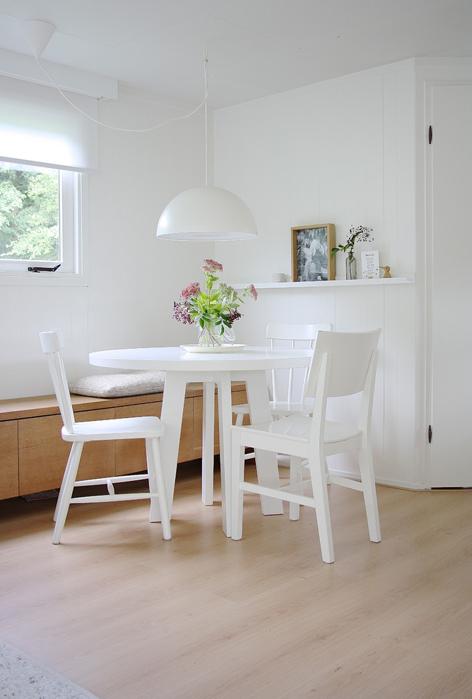Design ideas for a scandinavian dining room in Amsterdam with white walls.