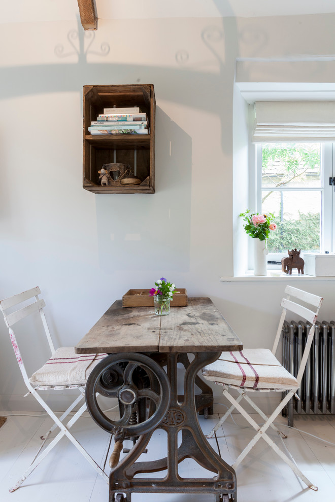 Example of a cottage chic dining room design in London