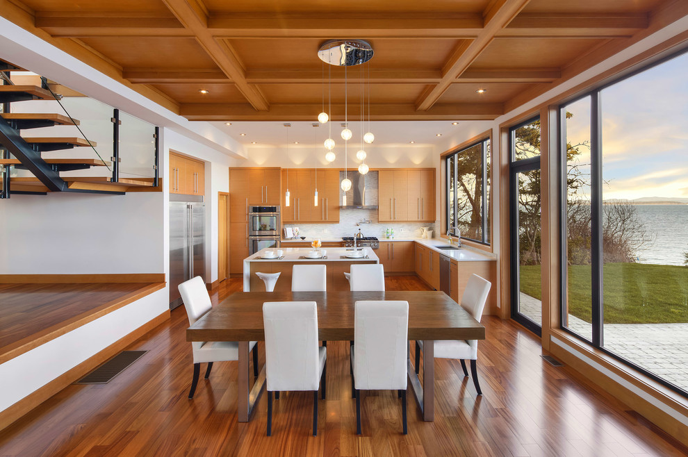 Réalisation d'une salle à manger ouverte sur la cuisine design de taille moyenne avec un sol en bois brun et aucune cheminée.