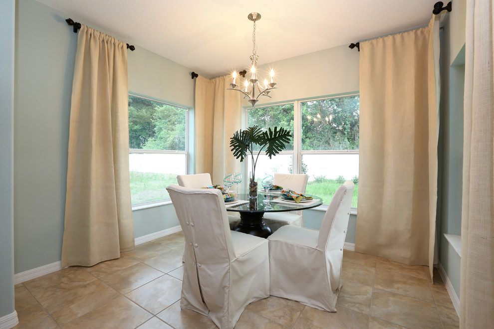 Example of a small transitional ceramic tile kitchen/dining room combo design in Orlando with green walls
