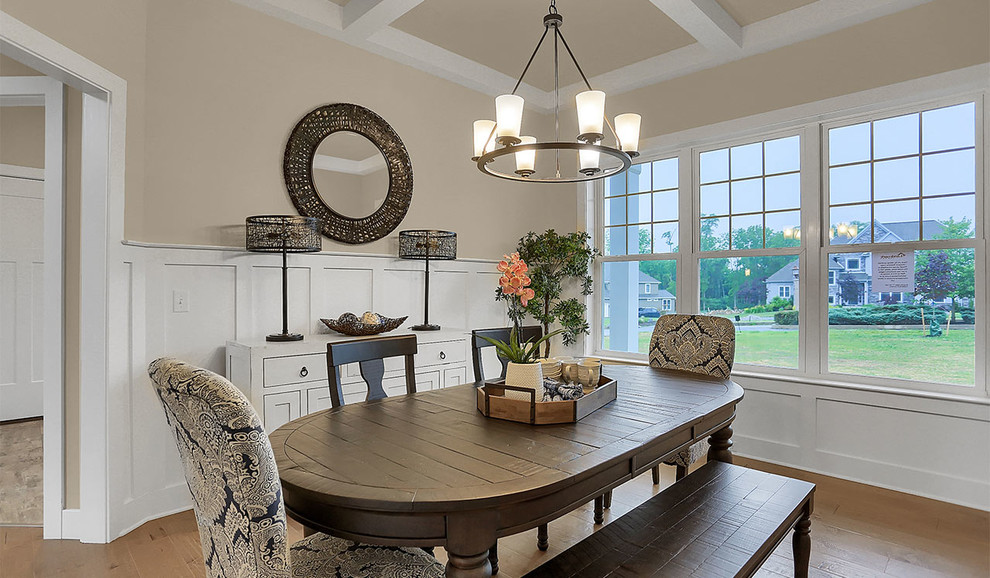 This is an example of an expansive traditional enclosed dining room in Other with grey walls and light hardwood flooring.