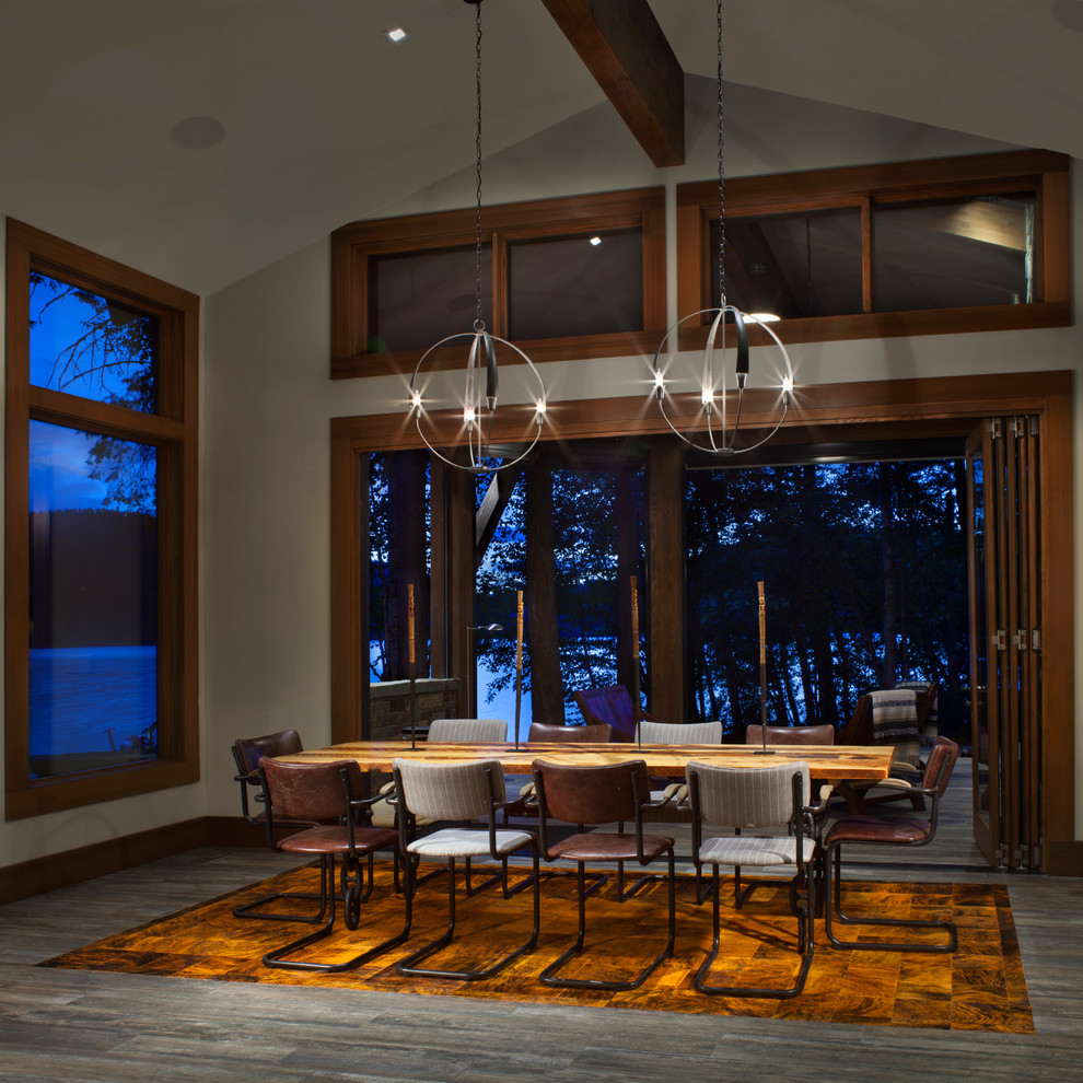 Mid-sized mountain style laminate floor and gray floor enclosed dining room photo in Other with white walls and no fireplace