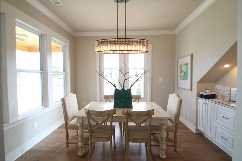 Inspiration for a traditional dining room in Little Rock with grey walls and light hardwood flooring.