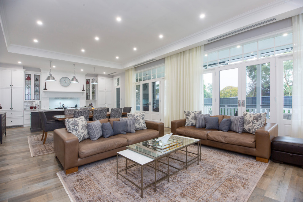 Esempio di un grande soggiorno design con pareti grigie, pavimento in gres porcellanato, pavimento marrone e soffitto a volta