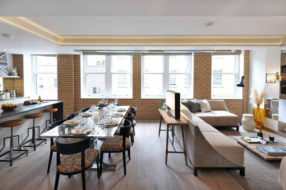 Photo of a contemporary dining room in London with white walls, medium hardwood flooring and brown floors.