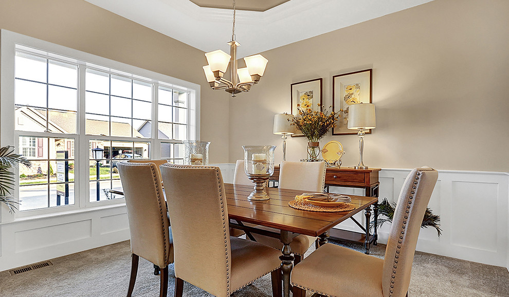 This is an example of a medium sized classic enclosed dining room in Other with beige walls, carpet and no fireplace.