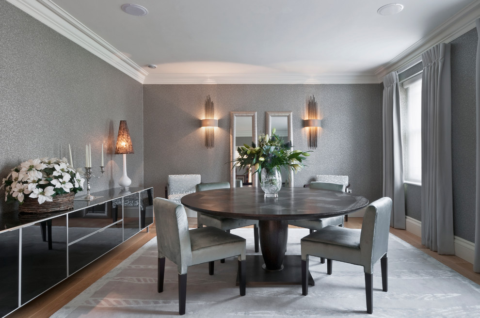 This is an example of a contemporary dining room in Buckinghamshire with feature lighting.