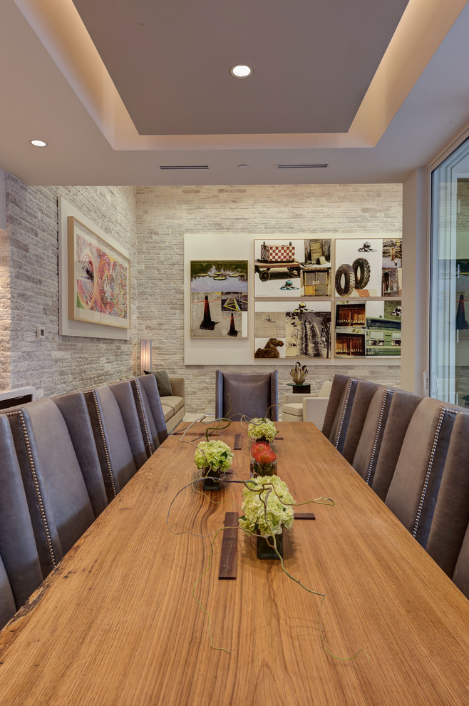 Exemple d'une salle à manger moderne avec un mur gris.