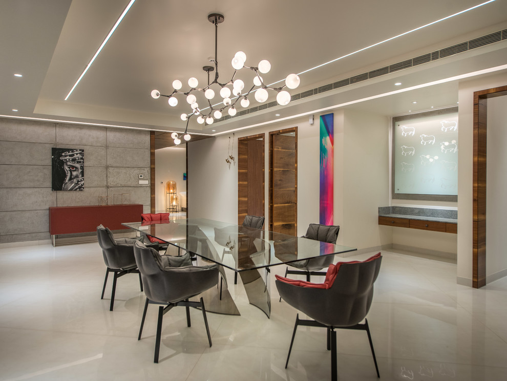 Large modern dining room in Hyderabad with beige floors.