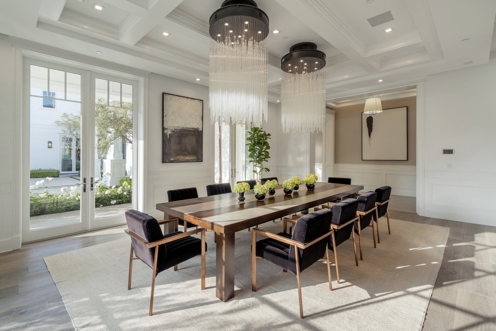 Photo of a traditional enclosed dining room in Los Angeles with white walls, medium hardwood flooring and grey floors.