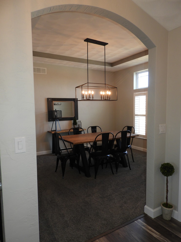 Example of a large transitional carpeted and gray floor dining room design in St Louis with beige walls and no fireplace