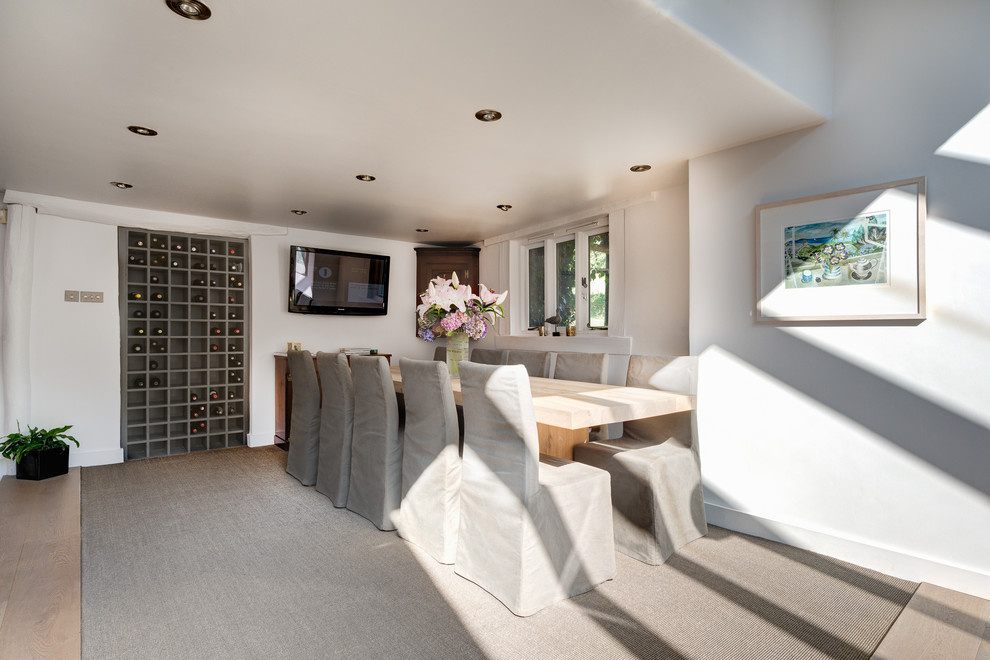 This is an example of a contemporary dining room in Devon with white walls.