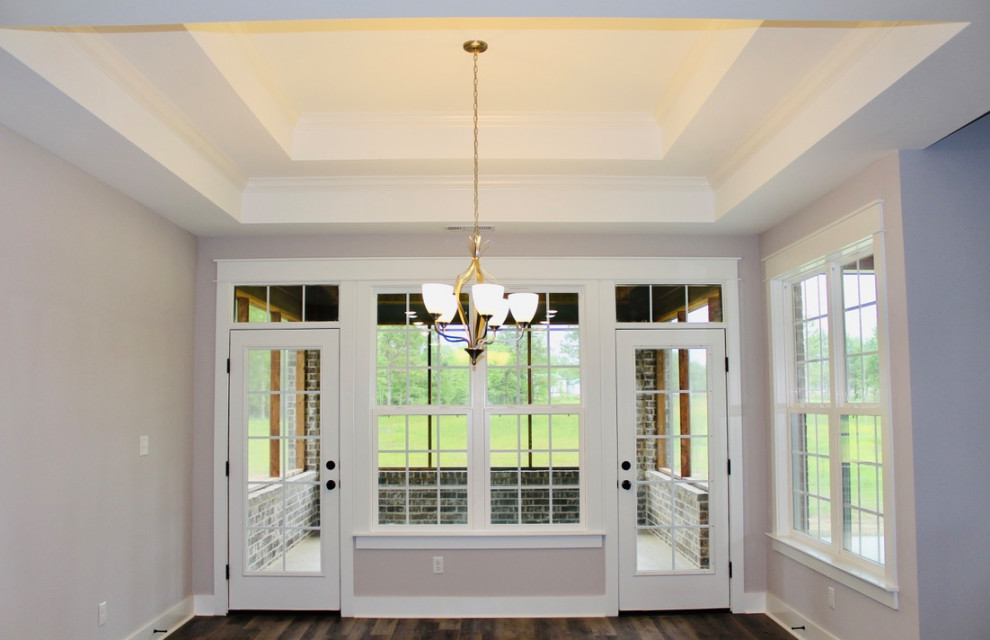 Example of a tray ceiling dining room design in Other