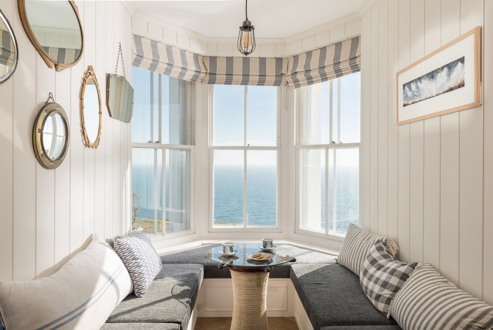 Photo of a medium sized coastal dining room in Cornwall with beige walls.