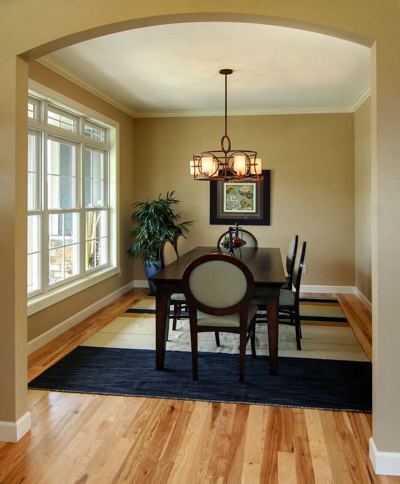 Photo of a medium sized traditional enclosed dining room in Minneapolis with beige walls, light hardwood flooring and no fireplace.