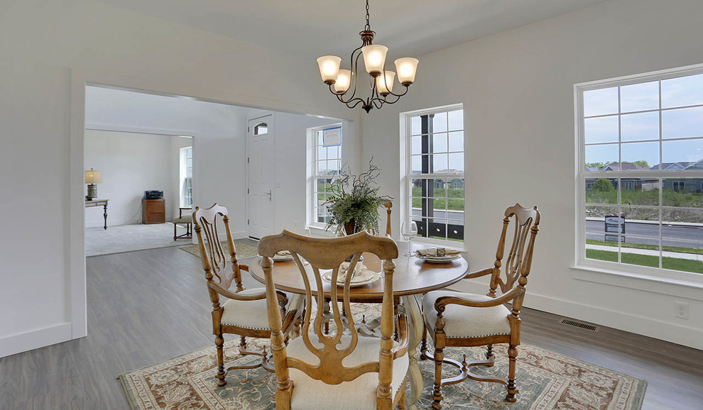 This is an example of a large classic enclosed dining room in Other with grey walls.