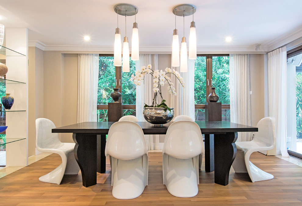 Dining room - contemporary medium tone wood floor dining room idea in Singapore with beige walls and no fireplace