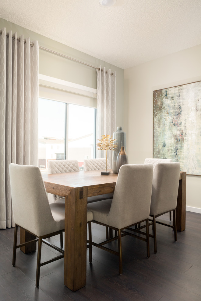 Inspiration for a contemporary dining room in Edmonton with beige walls, laminate floors, brown floors and no fireplace.