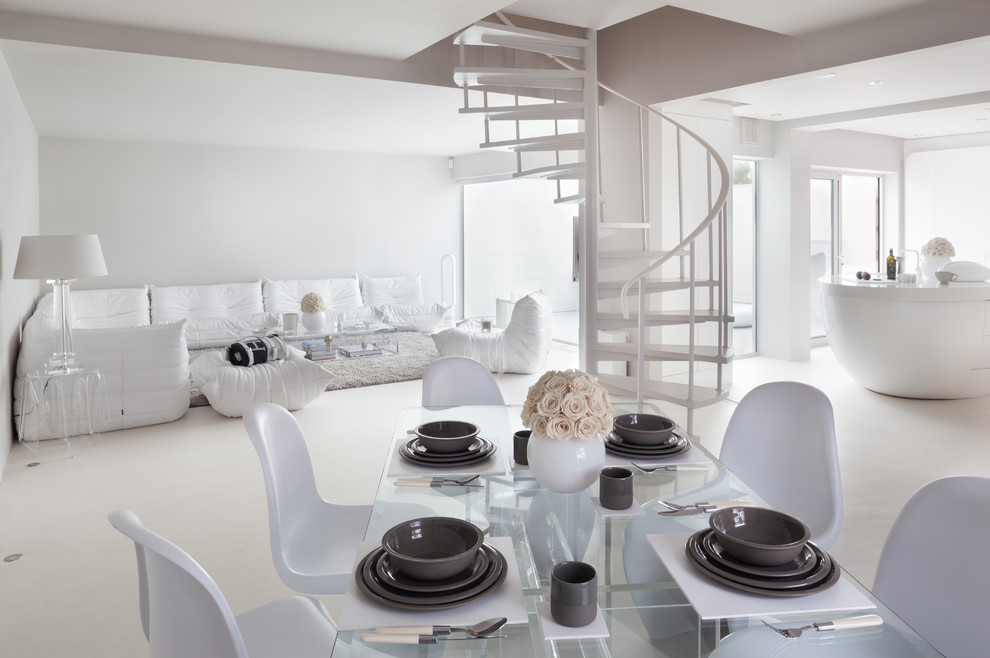 Contemporary dining room in London with white walls and feature lighting.