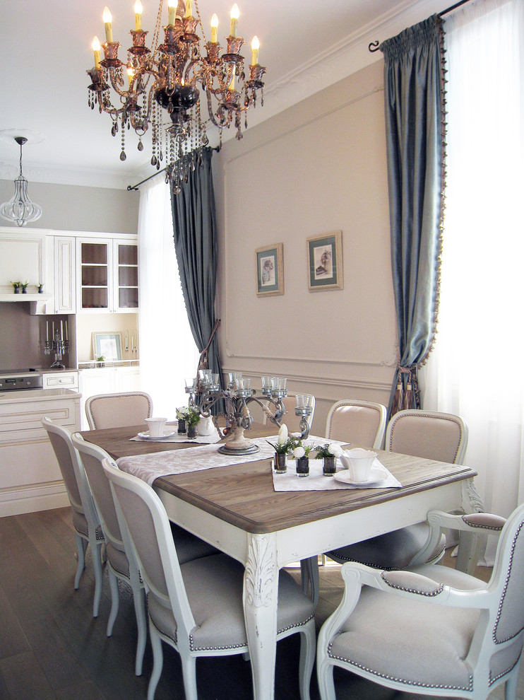 Foto di una sala da pranzo aperta verso la cucina bohémian di medie dimensioni con pareti beige e pavimento in legno massello medio
