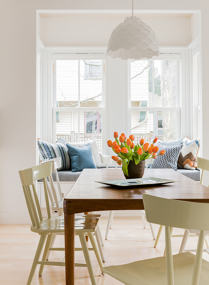 Dining room - scandinavian light wood floor dining room idea in Boston with white walls
