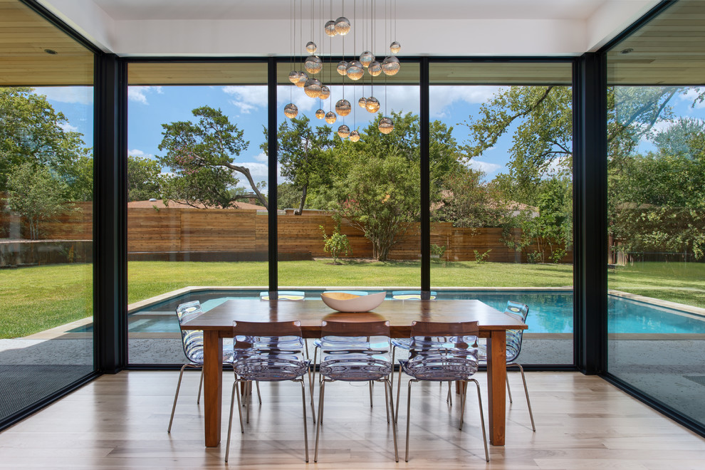 Contemporary dining room in Austin with light hardwood flooring.