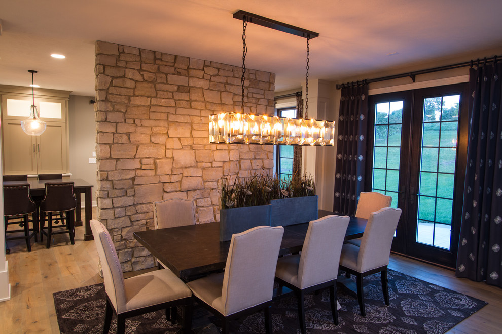 Photo of a large traditional open plan dining room in Omaha with beige walls, medium hardwood flooring, a standard fireplace and a wooden fireplace surround.