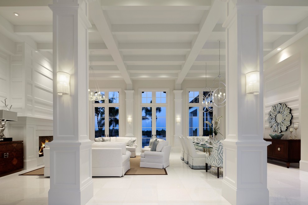 Photo of a large classic enclosed dining room in Miami with white walls, porcelain flooring, no fireplace, white floors and feature lighting.